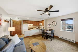 Living room featuring a baseboard radiator, recessed lighting, and a ceiling fan