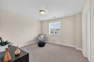 Unfurnished room featuring light colored carpet and baseboards