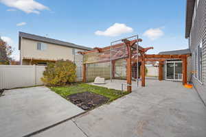 Fenced backyard featuring a pergola and a patio area