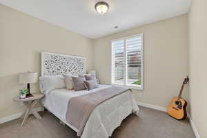 Carpeted bedroom featuring baseboards
