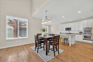 Dining room with light wood-type flooring and recessed lighting