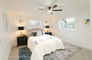 Bedroom featuring carpet, multiple windows, and ceiling fan