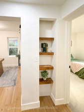 Corridor featuring light wood finished floors