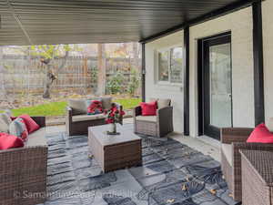 View of patio with an outdoor hangout area