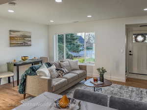 Living room with wood finished floors, recessed lighting, and a textured ceiling