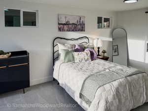 Carpeted bedroom featuring baseboards