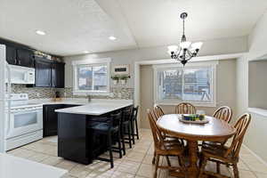 Fresh kitchen with new countertops, tile backsplash and lovely craftsman casing on windows