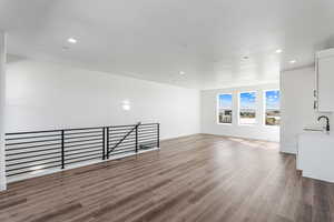 Empty room featuring recessed lighting, light wood-type flooring, and a textured ceiling