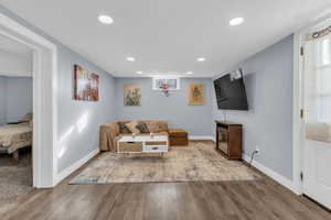 Living area featuring recessed lighting, wood finished floors, and a textured ceiling