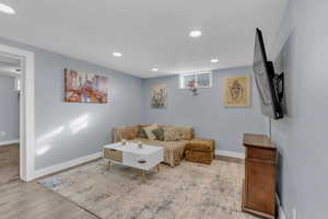 Living area featuring light wood-type flooring and recessed lighting