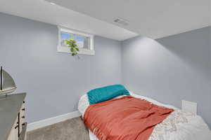 Carpeted bedroom with baseboards