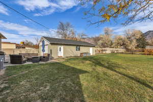 Rear view of property with outdoor lounge area, a patio, and a shingled roof