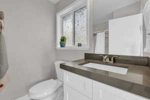Bathroom with vanity and curtained shower