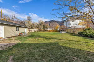 Fenced backyard with a mountain view