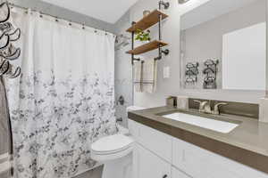 Full bathroom with vanity and toilet