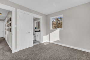 Carpeted spare room with baseboards