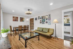 Living room featuring light wood finished floors and recessed lighting