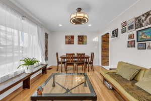 Dining space with light wood finished floors and recessed lighting