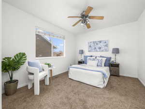 Carpeted bedroom featuring baseboards and a ceiling fan