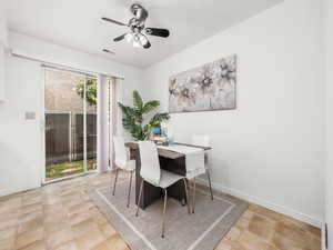Dining room with ceiling fan and light tile patterned floors