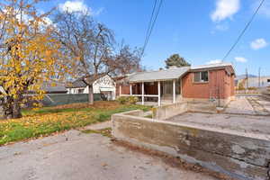 Ranch-style home featuring brick siding and a sunroom