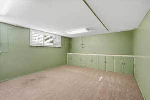 Carpeted spare room with baseboards