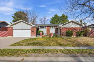 Ranch-style house featuring brick siding, concrete driveway, and a garage