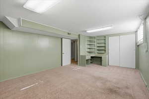 Basement with carpet floors and an office area
