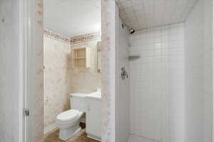 Bathroom featuring a stall shower, tile patterned flooring, and vanity