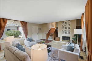 Living area with a fireplace and stairs