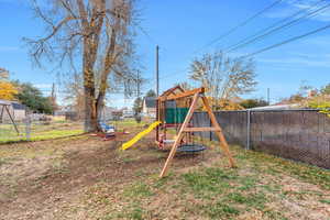 Fenced backyard with a playground