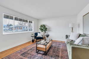 Living room featuring baseboards and real  hardwood finished floors