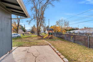 Fenced backyard with a playground
