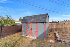 View of shed with a fenced backyard