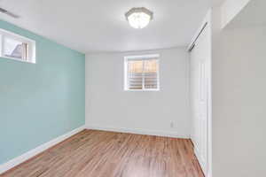 Unfurnished bedroom featuring wood finished floors and a closet