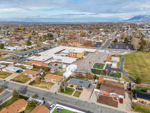 Aerial view of property's location with nearby suburban area and a mountain backdrop