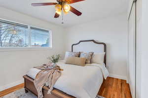 Bedroom with hardwood finished floors, a ceiling fan, and a closet