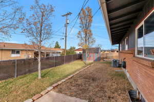 Fenced backyard with a storage shed