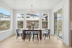 Sunroom / solarium featuring healthy amount of natural light and a chandelier