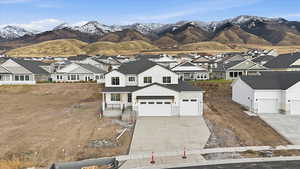 Modern farmhouse featuring a residential view, a mountain view, driveway, and board and batten siding