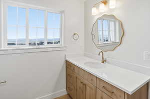 Bathroom featuring vanity and baseboards