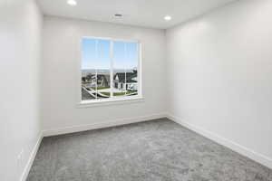 Unfurnished room featuring carpet and recessed lighting
