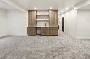 Bar area featuring light countertops, light colored carpet, recessed lighting, and open shelves