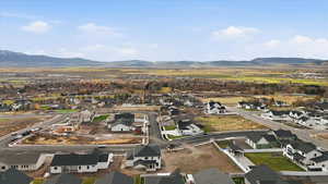 Aerial view of property's location featuring nearby suburban area and a mountain backdrop