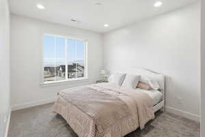 Carpeted bedroom with baseboards and recessed lighting