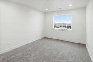 Spare room featuring carpet flooring and recessed lighting