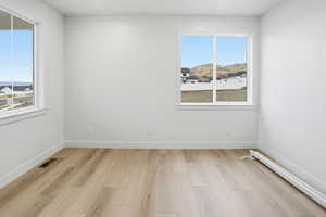 Office featuring light wood-style flooring and a mountain view