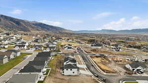 Aerial overview of property's location with nearby suburban area and a mountainous background
