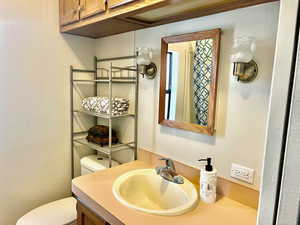 Half bathroom with vanity and toilet