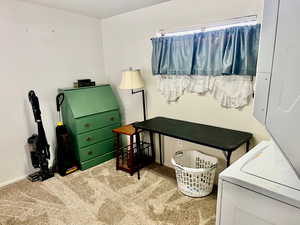 Carpeted office space with washer / dryer and baseboards